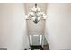 A high-ceiling foyer is illuminated by a stunning chandelier, with a white front door at 3863 Rosebay Way, Conyers, GA 30094
