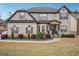 Two-story brick home features a well-manicured lawn and a welcoming front porch with decorative columns at 3863 Rosebay Way, Conyers, GA 30094