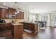 Open kitchen with granite countertops, stainless appliances, dark cabinets, and adjoining dining area at 3863 Rosebay Way, Conyers, GA 30094