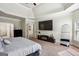Large main bedroom with wall-mounted TV, tall mirror and access to the bathroom at 3863 Rosebay Way, Conyers, GA 30094