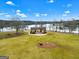A scenic view from the air, featuring a gazebo, lush green grass, and a tranquil lake at 211 Collierstown Way, Peachtree City, GA 30269