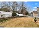 Well-maintained backyard featuring a white picket fence, garden beds, and verdant landscaping at 211 Collierstown Way, Peachtree City, GA 30269