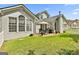 Expansive backyard with a stone patio that includes a table and chairs, and green grass at 211 Collierstown Way, Peachtree City, GA 30269