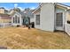 Expansive backyard featuring a stone patio, white picket fence, and lush landscaping at 211 Collierstown Way, Peachtree City, GA 30269
