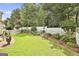 Beautiful backyard features a well-manicured lawn, garden and a white picket fence at 211 Collierstown Way, Peachtree City, GA 30269