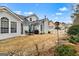 Spacious backyard with a white picket fence, stone patio, and lush landscaping at 211 Collierstown Way, Peachtree City, GA 30269