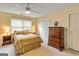 Cozy bedroom features neutral paint, ceiling fan and a window providing natural light at 211 Collierstown Way, Peachtree City, GA 30269