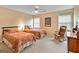 Spacious bedroom with two beds, ceiling fan and rocking chair at 211 Collierstown Way, Peachtree City, GA 30269