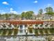 A bridge with sign spelling 'Lake Peachtree', with water flowing over the dam under the bridge at 211 Collierstown Way, Peachtree City, GA 30269