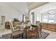 Open-concept dining area with wood table setup for an elegant meal at 211 Collierstown Way, Peachtree City, GA 30269