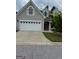 Traditional home boasts a two-car garage, well-maintained lawn, and classic architectural details at 211 Collierstown Way, Peachtree City, GA 30269
