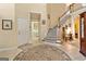 Inviting foyer with staircase, tiled floor, and stylish rug at 211 Collierstown Way, Peachtree City, GA 30269