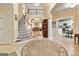Bright foyer with staircase, decorative rug, and views into the living room and kitchen at 211 Collierstown Way, Peachtree City, GA 30269