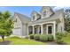Charming home featuring a stone facade, white pillars, tidy bushes, and well manicured landscaping at 211 Collierstown Way, Peachtree City, GA 30269