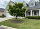 Well maintained home featuring stone accents, white pillars, and tidy landscaping at 211 Collierstown Way, Peachtree City, GA 30269