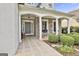 Inviting front porch with stone accents, white pillars, and a tile floor at 211 Collierstown Way, Peachtree City, GA 30269
