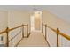 Second-floor hallway with wood and white railings, carpet and neutral paint at 211 Collierstown Way, Peachtree City, GA 30269