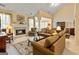 Open-concept living room with high ceilings, fireplace, and cozy furniture at 211 Collierstown Way, Peachtree City, GA 30269