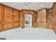 Spacious living room with wood paneling, built-in bookshelves, and neutral carpet at 211 Collierstown Way, Peachtree City, GA 30269