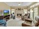 Comfortable living room with cozy fireplace, tv, ceiling fan and lots of natural light, perfect for relaxing at 211 Collierstown Way, Peachtree City, GA 30269