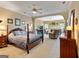Serene main bedroom with a four-poster bed, fireplace, and sitting area at 211 Collierstown Way, Peachtree City, GA 30269