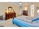 Cozy main bedroom features a ceiling fan and antique furniture at 211 Collierstown Way, Peachtree City, GA 30269