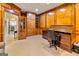 Office with wood paneling, built-in bookcase, and roll top desk that leads into the kitchen at 211 Collierstown Way, Peachtree City, GA 30269