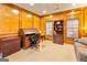 Office with wood paneling, built-in cabinets, and a roll-top desk with a neutral carpet at 211 Collierstown Way, Peachtree City, GA 30269