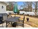 Lovely courtyard patio with stone flooring featuring a dining table with umbrella and a BBQ grill at 211 Collierstown Way, Peachtree City, GA 30269