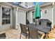 View of a patio area with a black table with chairs and a barbecue grill at 211 Collierstown Way, Peachtree City, GA 30269