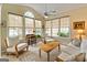 Bright sunroom featuring large windows, neutral decor, and a functional workspace at 211 Collierstown Way, Peachtree City, GA 30269