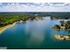 Expansive aerial view of lakefront property surrounded by lush greenery and blue skies at 2304 Larchmont Ct, Villa Rica, GA 30180