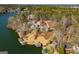 Picturesque aerial view of a waterfront estate with lush greenery and private boat docks along the serene lake at 2304 Larchmont Ct, Villa Rica, GA 30180