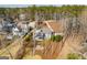 Aerial view showcasing the house nestled on a wooded lot with lake access and private dock at 2304 Larchmont Ct, Villa Rica, GA 30180