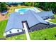 Aerial view of community pool and clubhouse with lush lawns and mature trees at 2304 Larchmont Ct, Villa Rica, GA 30180