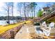 Paver patio with outdoor seating overlooking the lake and boat dock at 2304 Larchmont Ct, Villa Rica, GA 30180