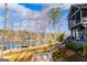 Lakeside home featuring a sprawling backyard, a lakeside view, and steps down to a patio and the lake at 2304 Larchmont Ct, Villa Rica, GA 30180