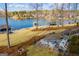 Lakeside backyard patio with comfortable seating and stunning water views, accessible by stairs at 2304 Larchmont Ct, Villa Rica, GA 30180