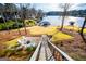 Aerial backyard shot with lake, dock, patio, and lush landscaping at 2304 Larchmont Ct, Villa Rica, GA 30180