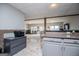 A well lit basement area with light colored floors and accents plus bar and view to the Gathering room at 2304 Larchmont Ct, Villa Rica, GA 30180