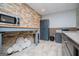 Basement kitchenette with a microwave, cabinets, and accent wall with decorative plates at 2304 Larchmont Ct, Villa Rica, GA 30180
