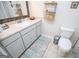 Bright bathroom featuring vanity with large mirror and neutral patterned rug at 2304 Larchmont Ct, Villa Rica, GA 30180