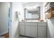 Bright bathroom featuring vanity with large mirror and shelving with towels at 2304 Larchmont Ct, Villa Rica, GA 30180