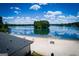 Scenic beach with clear blue lake views and a glimpse of the rooftop on a sunny day at 2304 Larchmont Ct, Villa Rica, GA 30180