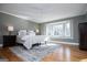 This bedroom features large windows with a sitting area, a ceiling fan, and classic nightstands at 2304 Larchmont Ct, Villa Rica, GA 30180