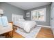 Cozy bedroom with a queen bed, neutral color scheme, wood floors, and bright natural light at 2304 Larchmont Ct, Villa Rica, GA 30180