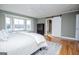 Light bedroom with a large sunny window with water views, a dresser, and a sliding barn door to the bathroom at 2304 Larchmont Ct, Villa Rica, GA 30180