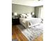 Comfortable bedroom with a large rug, bedside tables, and decorative lamps at 2304 Larchmont Ct, Villa Rica, GA 30180