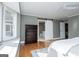 Light bedroom with a large sunny window, a dresser, and a sliding barn door to the bathroom at 2304 Larchmont Ct, Villa Rica, GA 30180