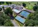 Aerial view showcases community pool, tennis, golf course, and parking amid lush greenery at 2304 Larchmont Ct, Villa Rica, GA 30180